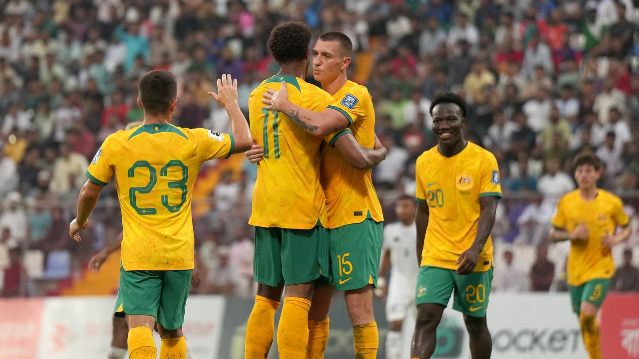 Kusini Yengi (second from left) is congratulated by his Socceroos teammate Mitch Duke after scoring against Bangladesh. Picture: Thananuwat Srirasant/Getty Images