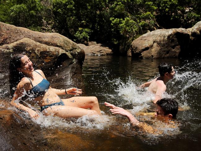 Cassy Curtis, Taine Evans and John Gooby (all aged 15) cool themselves down at Jellybean Pool in the Blue Mountains National Park. Picture: Tim Hunter