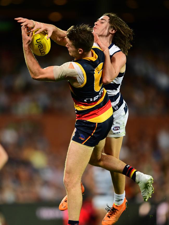 Bryce Gibbs spills a mark under pressure from Geelong rookie Gryan Miers. Picture: Mark Brake/Getty Images