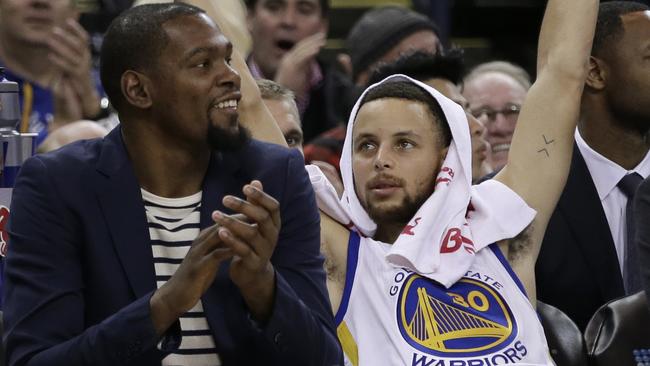Golden State Warriors' Kevin Durant, left, and Stephen Curry.