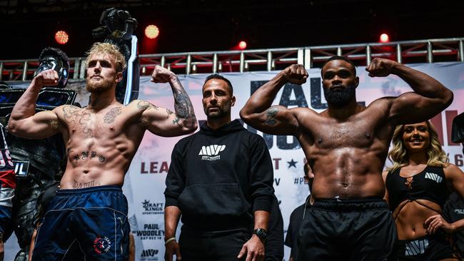 Jake Paul and Tyron Woodley gesture at their weigh-in ahead of their boxing fight. (Photo by CHANDAN KHANNA / AFP)