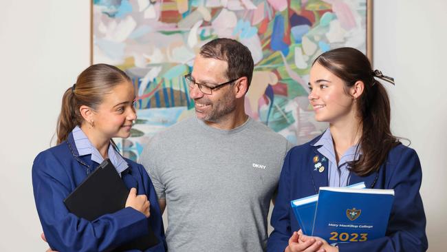 NEWS ADVDad Anthony Martini and his daughters Ella Martini 12yrs old - year 7 and Ava Martini 15yrs old - year 10 who are going to Mary Mackillop college, which has reduced its fees this year.Image/Russell Millard Photography