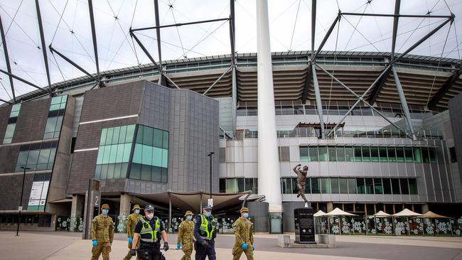 The MCG is used to big crowds at this time of year — not police and defence force patrols, as coronavirus restrictions continue in Victoria. Picture: Mark Stewart