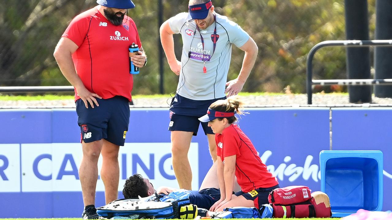 Demons coach Simon Goodwin checks on Jake Lever. Picture: Quinn Rooney/Getty Images