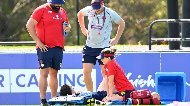 Demons coach Simon Goodwin checks on Jake Lever. Picture: Quinn Rooney/Getty Images