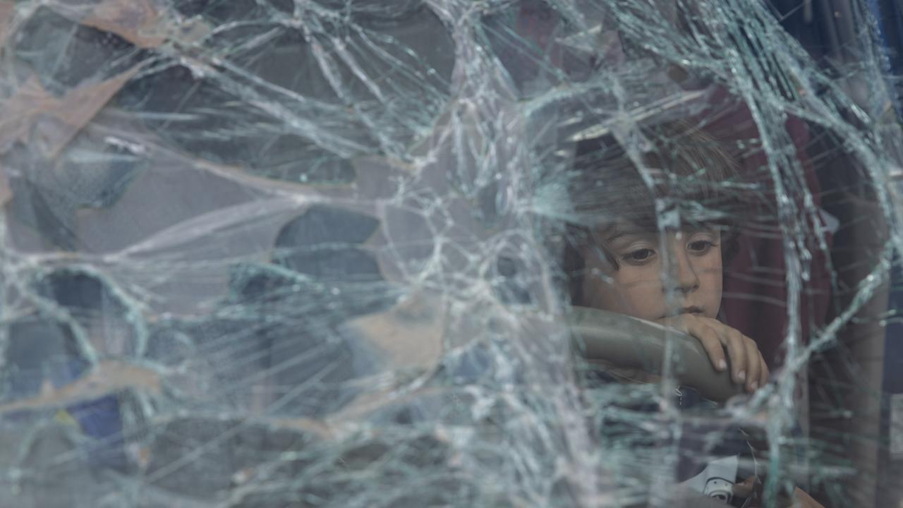 A boy from Mariupol looks out through the smashed windscreen of his family's car after arriving with his family at an evacuation point for people fleeing Mariupol. Picture: Chris McGrath/Getty Images