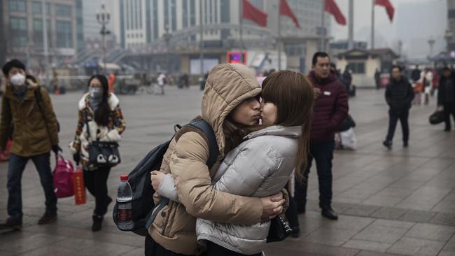 A couple kiss goodbye at Beijing Railway Station during the Spring Festival in 2017. Picture: Getty Images