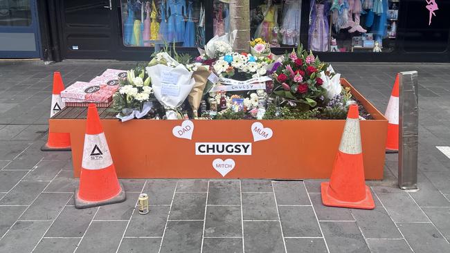 Tributes on Little Malop St near where Mr Sykes was allegedly murdered.