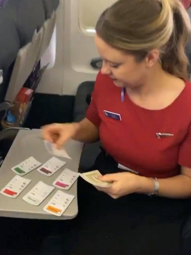 One of the Virgin Australia hosties plays a board game with the players. SUPPLIED