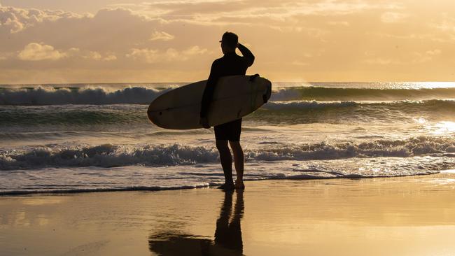 Q WEEKEND Sunrise, people walking on the beach at Currumbin for a story about daylight saving.Picture: NIGEL HALLETT