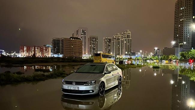 A car is left on a flooded street. Picture: Giuseppe Cacace/AFP