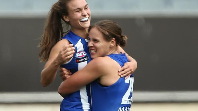 Jasmine Garner celebrates a goal with Ash Riddell.