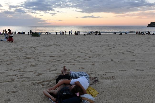 Revellers during the sunrise on New Years Day at Bondi Beach in Sydney. Picture: AAP