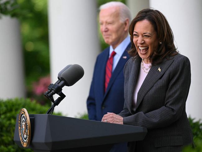 US President Joe Biden listens as Vice President Kamala Harris delivers remarks at a reception celebrating Asian American, Native Hawaiian, and Pacific Islander Heritage Month in the Rose Garden of the White House in Washington, DC on May 13, 2024. (Photo by Mandel NGAN / AFP)