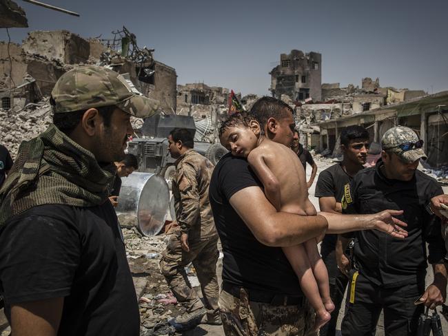 An unidentified young boy who was carried out of the last ISIS controlled area in the Old City by a man suspected of being a militant is cared for by Iraqi Special Forces soldiers. The soldiers suspected the man had used the boy as a human shield in order to try and escape as he did not know the child’s name and claimed he had just found him alone in the street. Picture: Ivor Prickett for the New York Times/World Press Photo