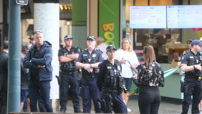 Police waiting for the scene walk through to start in Surfers Paradise. Picture: Richard Gosling