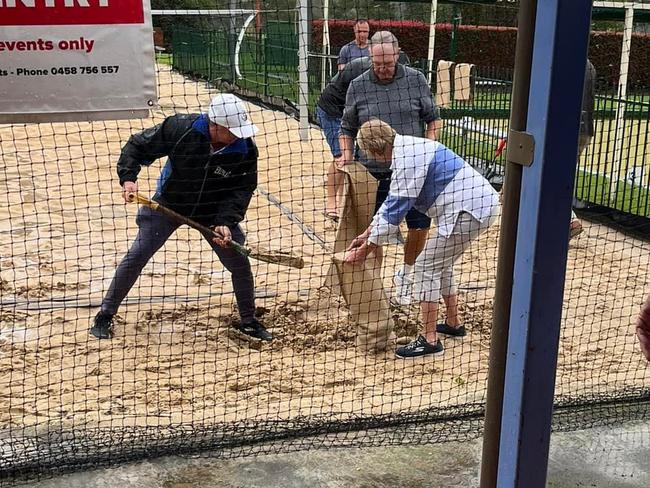 Volunteers fill sandbags to try to protect their beloved Camden Sporties club from the impending flood.