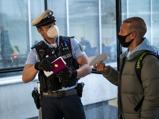 Border police check passengers arriving on a flight from Spain into Germany to be sure they can show evidence of a recent Covid-19 test. Picture: Getty Images