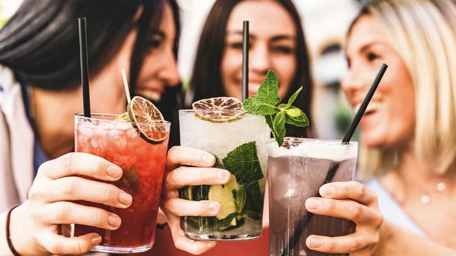 Cocktails. Friends. Group of happy friends toasting and drinking fancy cocktails at bar terrace-Three Young girls drink mojito and clinking glass together at pub enjoying happy hour at summer party- Life Style concept Picture: istock