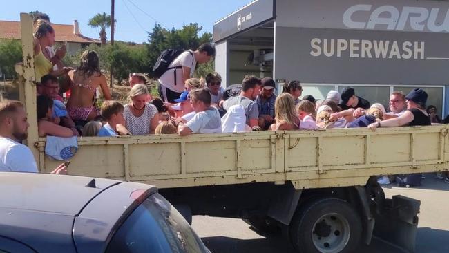 Tourists are evacuated during bushfires on the Greek island of Rhodes. Picture: AFP