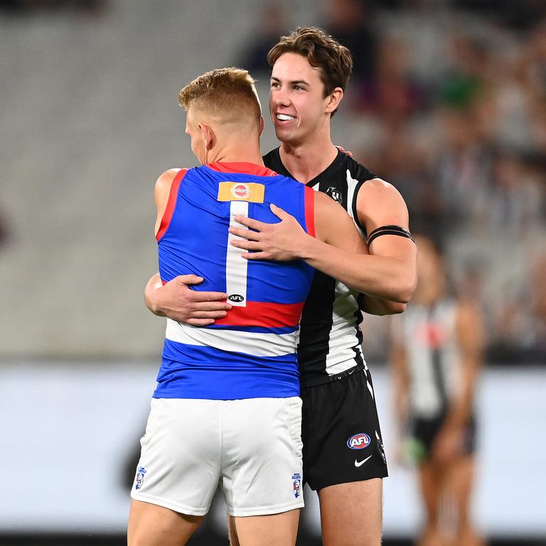 Treloar hugs former teammate Tyler Brown before the first bounce. Picture: Getty Images