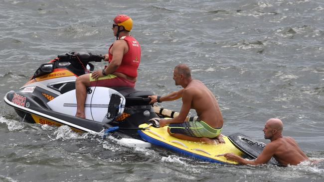 Surfer rescued by lifeguards from Stradbroke Island at the The Spit on the Gold Coast. (Photo/Steve Holland)