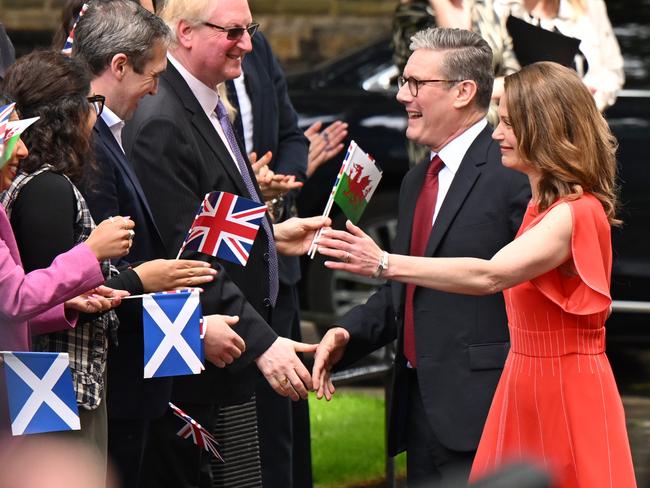 New UK Prime Minister Sir Keir Starmer and wife Victoria greet supporters as they enter Downing Street following Labour's landslide election victory. Picture: Getty Images