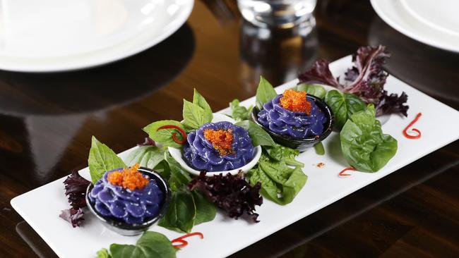 Yada Thai restaurant has just opened at Trinity Beach, with the 3 piece violet dumplings, originally created with special ingredients for the Thai royal family, proving popular with diners. Co owner of Yada Thai restaurant Eye Taveesuk serves a platter of the violet dumplings. Picture: Brendan Radke