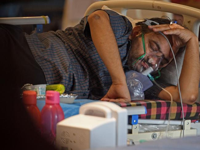 A coronavirus patient rests inside a banquet hall temporarily converted into a COVID care centre in New Delhi. Picture: AFP