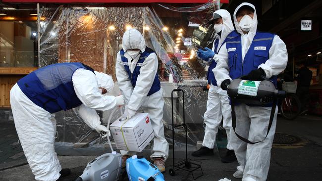 SEOUL, SOUTH KOREA - FEBRUARY 24: Disinfection professionals wearing protective gear prepare to disinfect against the coronavirus (COVID-19) at a traditional market on February 24, 2020 in Seoul, South Korea. South Korea has raised the coronavirus alert to the "highest level" as confirmed case numbers keep rising. Government reported 161 new cases of the coronavirus (COVID-19) bringing the total number of infections in the nation to 763, with the potentially fatal illness spreading fast across the country. (Photo by Chung Sung-Jun/Getty Images) *** BESTPIX ***