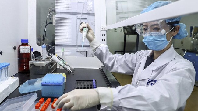 A staff member at state-owned COVID-19 vaccine production plant SinoPharm works with a test sample in Beijing, China, in April. Picture: AP