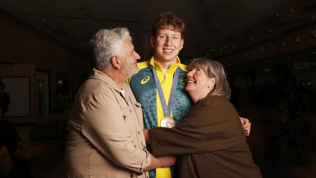 Max Giuliani with dad Mick and mum Jo. Tasmanian Olympic bronze medal winning swimmer Max Giuliani arrives back in Hobart after the Paris games. Picture: Nikki Davis-Jones