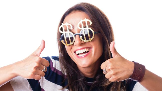 Laughing woman with Dollar sunglasses showing thumbs up with both hand, studio shot isolated on white; money celebration generic