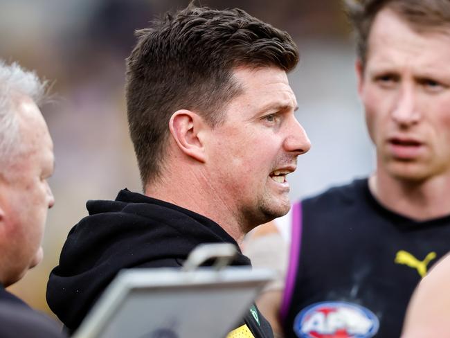 MELBOURNE, AUSTRALIA - JULY 22: Andrew McQualter, Interim Senior Coach of the Tigers addresses his players during the 2023 AFL Round 19 match between the Richmond Tigers and the Hawthorn Hawks at the Melbourne Cricket Ground on July 22, 2023 in Melbourne, Australia. (Photo by Dylan Burns/AFL Photos via Getty Images)