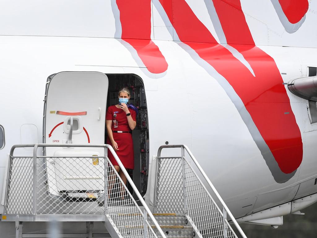 A Virgin Australia flight crew member wearing a face mask after her flight arrives into Ballina Byron Gateway Airport. Picture: Getty Images