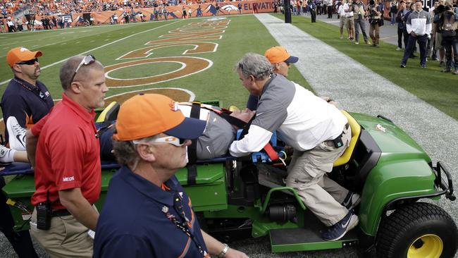 Denver Broncos offensive co-ordinator Wade Phillips is carted off the field.