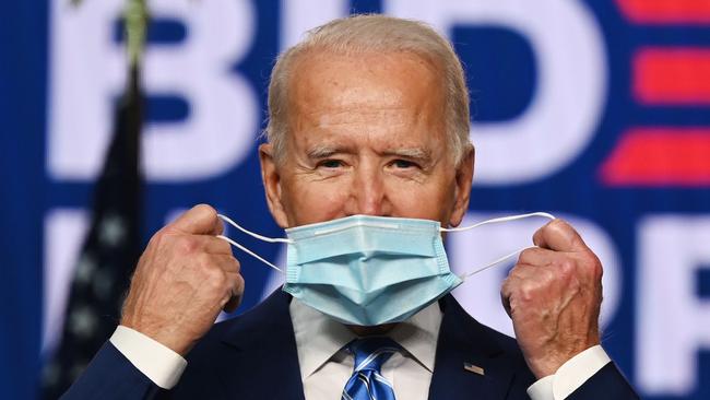 President-elect Joe Biden puts on his face mask. Photo: Jim Watson/AFP