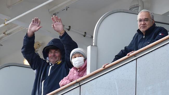 Passengers onboard the Diamond Princess cruise ship look out from their balconies as the ship docks at the Daikoku Pier Cruise Terminal in Yokohama port on February 6, 2020. (Photo by Kazuhiro NOGI / AFP)