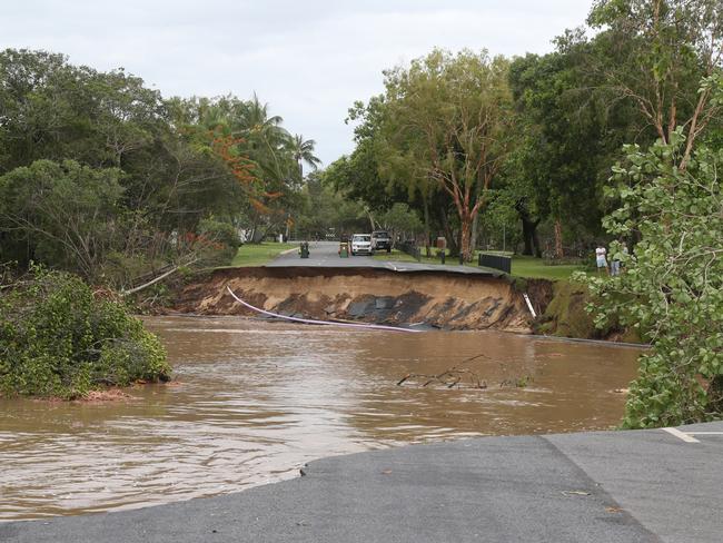 A huge section of Casuarina St at Holloways Beach has been swept away by the torrent that tore through the Cairns suburb on Sunday. Picture: Peter Carruthers