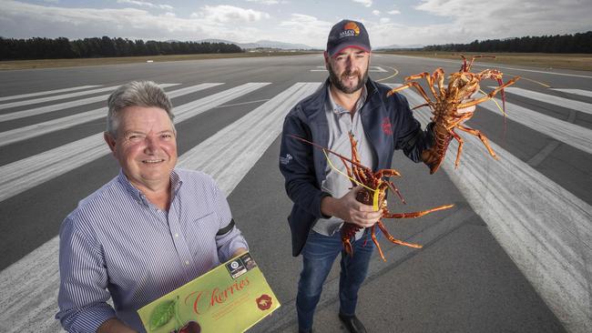 Reid Fruits marketing manager Tony Coad and Tasmanian Rock Lobster Processors Association President Michael Blake on the runway at the Hobart International Airport. Picture: Chris Kidd.