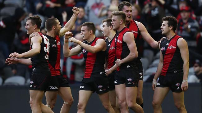 Essendon players celebrate on the final siren on Sunday.