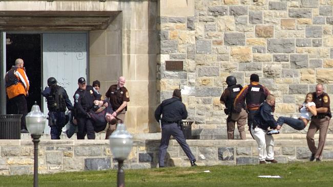 Injured occupants are carried out of Norris Hall at Virginia Tech. Picture: Alan Kim