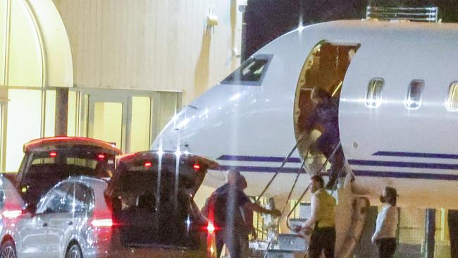 Elton leaves his plane after a post-curfew landing at Sydney Airport. Picture: Media Mode