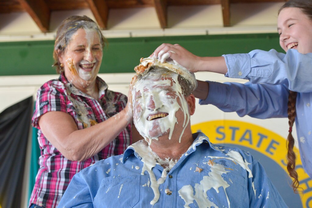 Principal Pauline Porch, teacher Norm Horan and Shalom White.PIE IN THE FACE - Mt Larcom State School raises money for drought relief. Picture: Mike Richards GLA140918PIEF