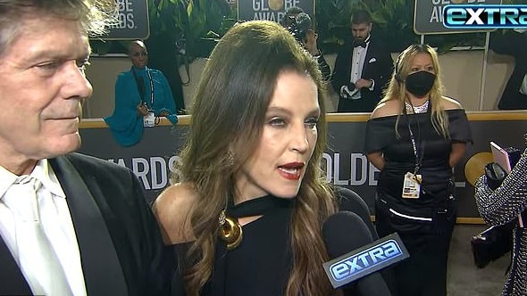 Lisa Marie held onto friend Jerry Schilling while being interviewed on the Golden Globes red carpet on Tuesday.