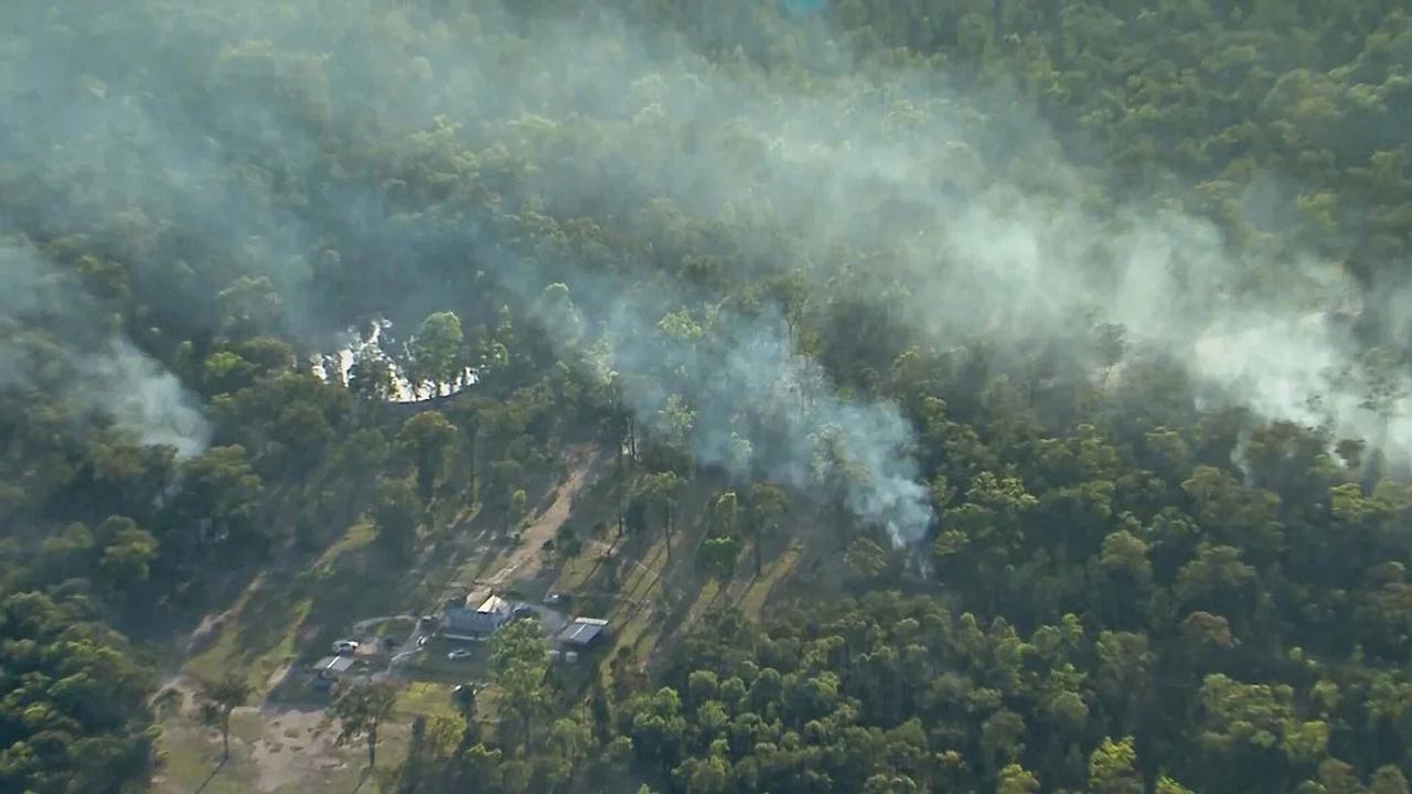 An aerial view of the scene at a property in Wieambilla where the shooting took place shows several fires burning. Source: Nine