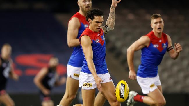 Harley Bennell boots Melbourne forward during Saturday’s win over Carlton.