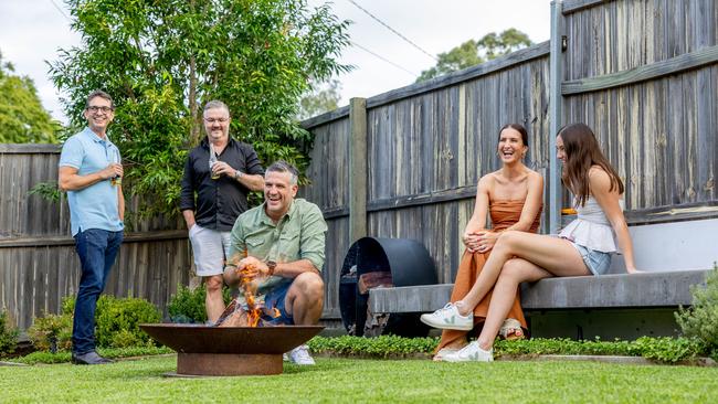 Dennis entertains family and friends around the fire pit. Picture by Luke Marsden.