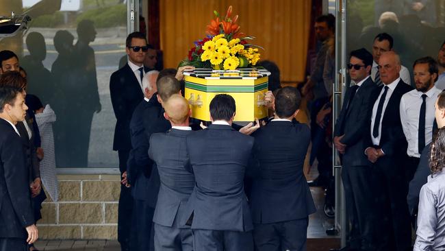 Yellow was Morgan Huxley’s favourite colour. He was laid to rest in a yellow coffin adorned with yellow flowers at Macquarie Park Crematorium. Picture: Bradley Hunter