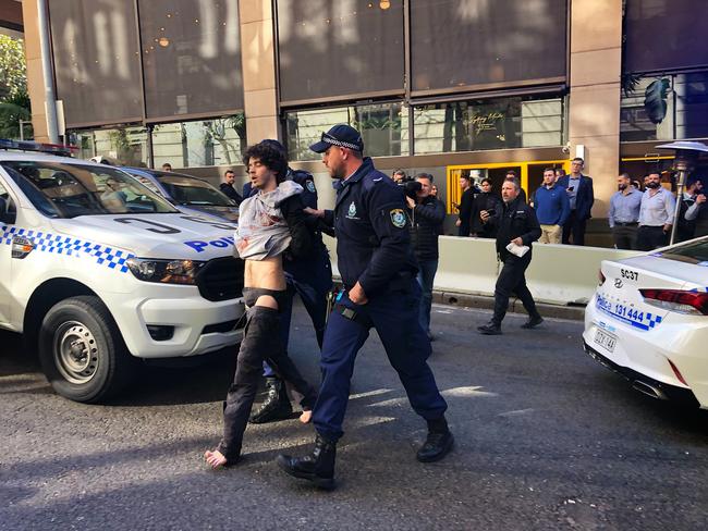 Police escort the man from the scene near Clarence Street in Sydney. Picture: Kartik Lad